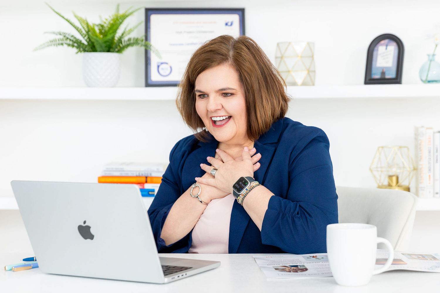 Vicki laughing at her desk during a coaching call