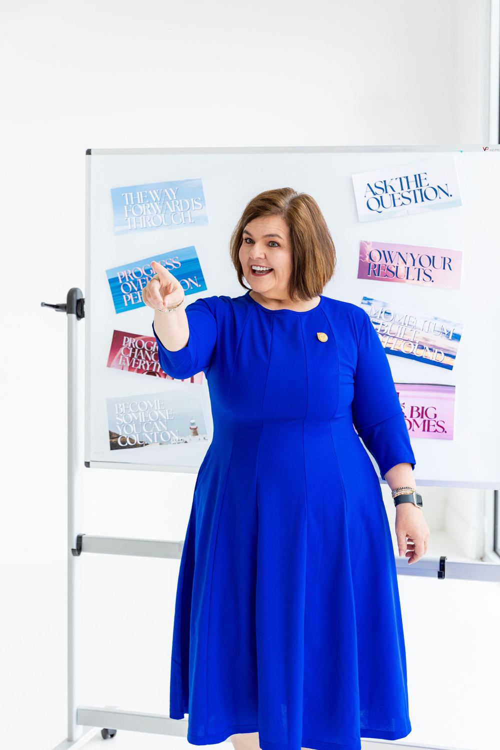 Vicki Christensen coaching at a whiteboard covered in planning notes